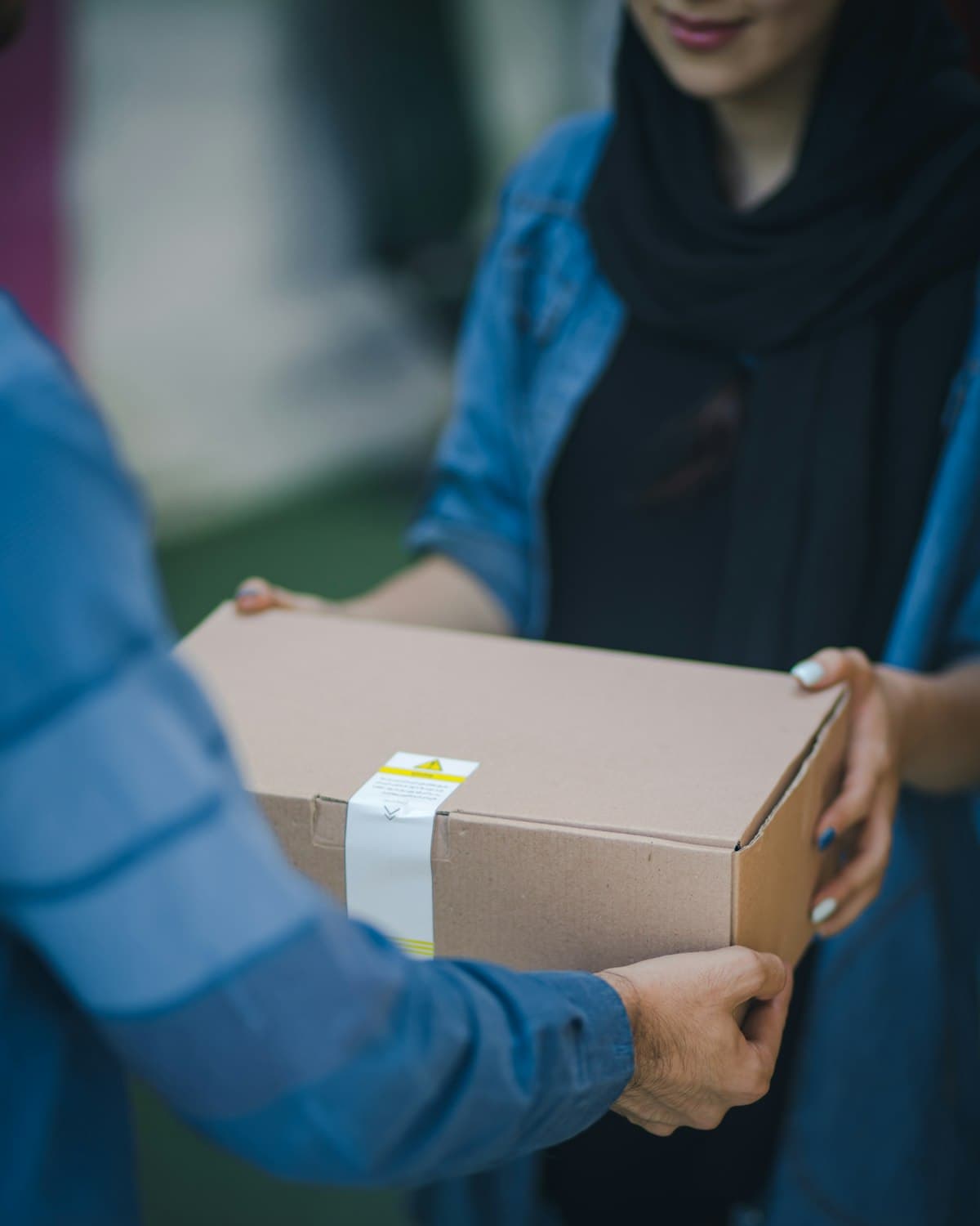 Hands exchanging a parcel package